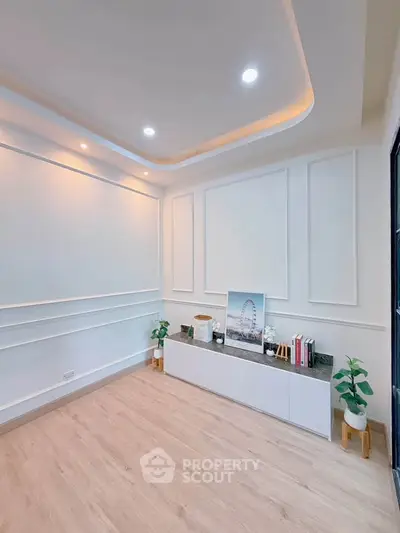 Elegant modern living room with stylish ceiling lights and sleek wooden flooring.