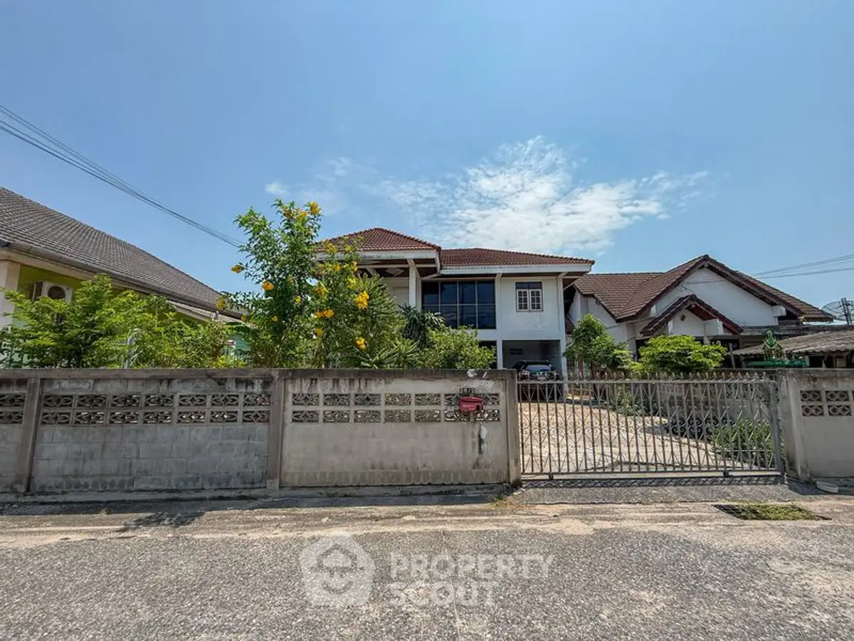 Charming suburban house with spacious driveway and lush garden, perfect for family living.