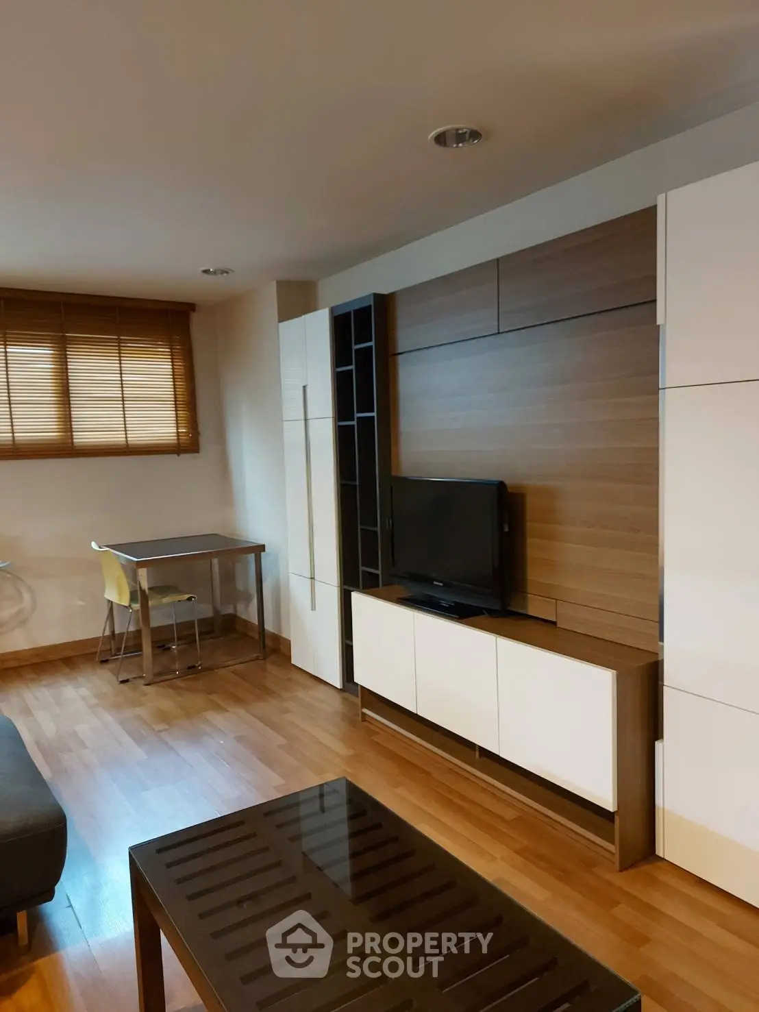 Modern living room with sleek wooden flooring and stylish TV unit