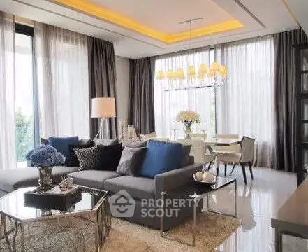 Luxurious living room with elegant decor and large windows offering natural light.