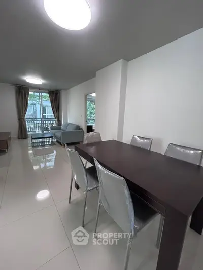 Spacious modern living room with dining area and large windows for natural light.
