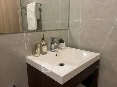 Modern bathroom with elegant sink and stylish decor accents.