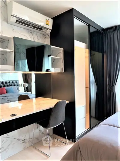 Modern bedroom with sleek black wardrobe and stylish marble vanity desk