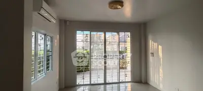 Spacious living room with large windows and balcony access in modern home.