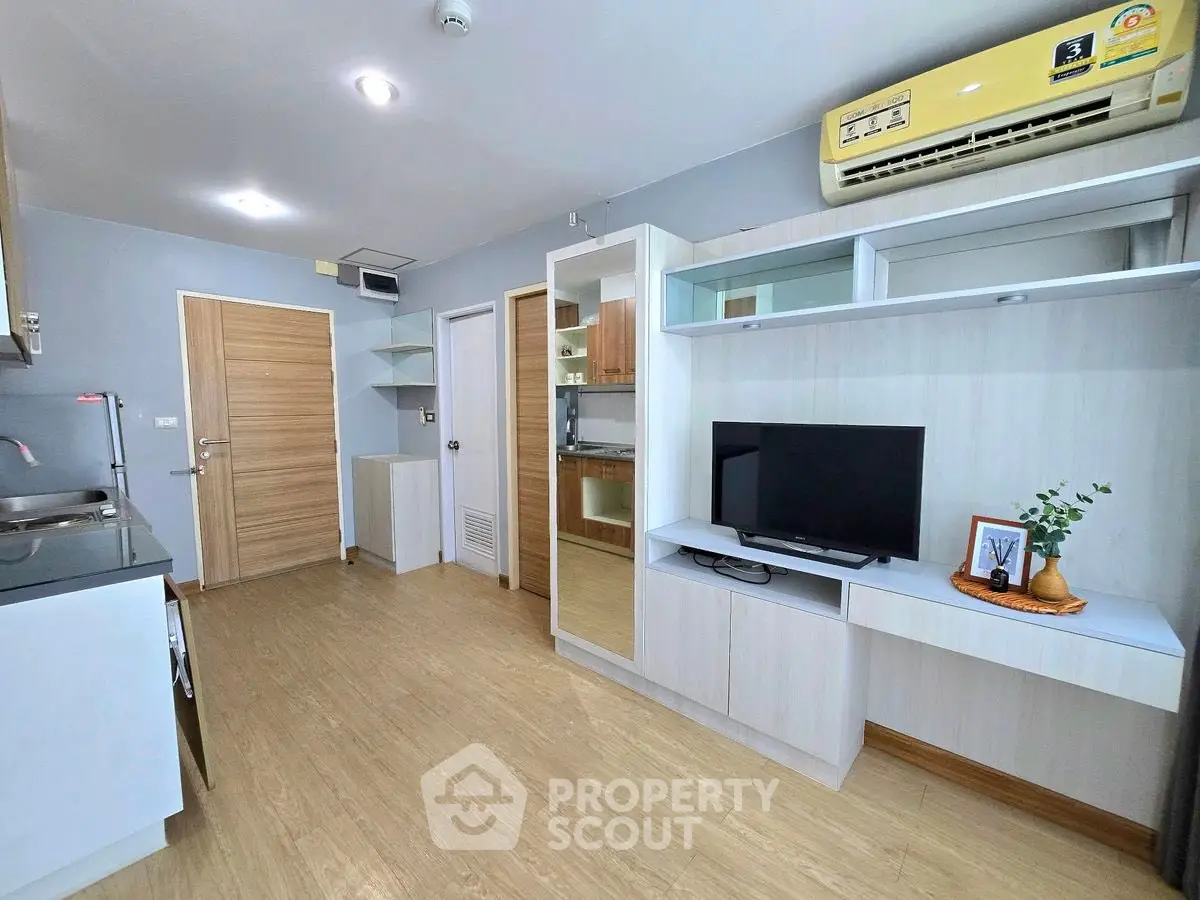 Modern living room with sleek furniture and air conditioning unit