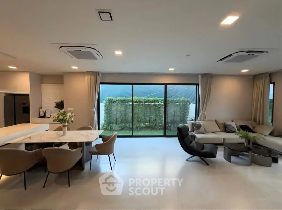 Spacious modern living room with open layout and garden view