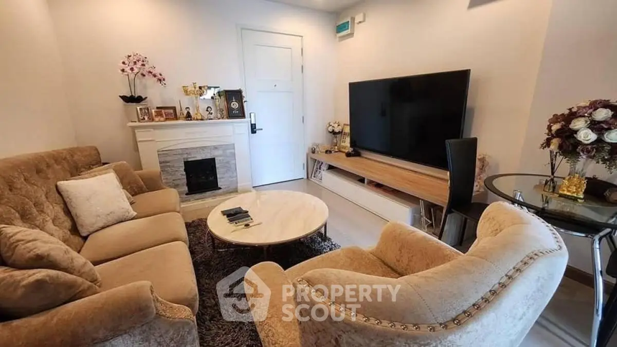 Cozy living room with plush seating and large TV, perfect for relaxation.