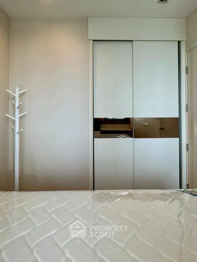 Modern bedroom with sleek closet and minimalist decor