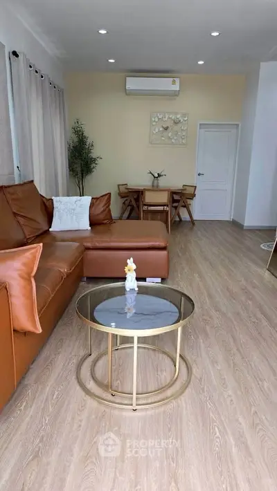 Spacious living room with modern decor and elegant furniture, perfect for relaxation and entertaining guests.