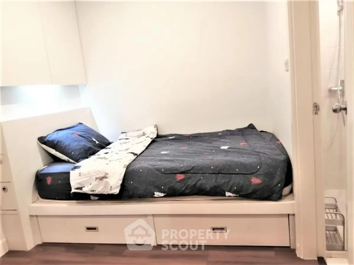 Cozy bedroom with built-in storage bed and modern decor, perfect for urban living.
