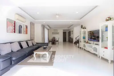 Spacious and bright living room with modern decor and large sectional sofa.