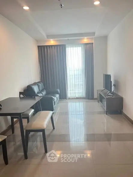 Modern living room with sleek furniture and large window for natural light.