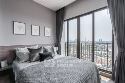 Modern bedroom with large windows offering stunning city views and elegant decor.