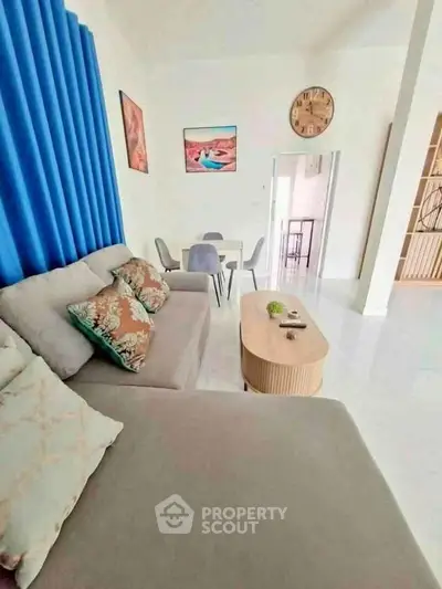 Modern living room with stylish decor and comfortable seating in a bright apartment.