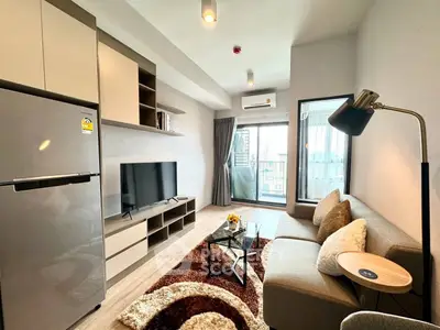 Modern living room with cozy sofa, stylish decor, and large window offering city views.