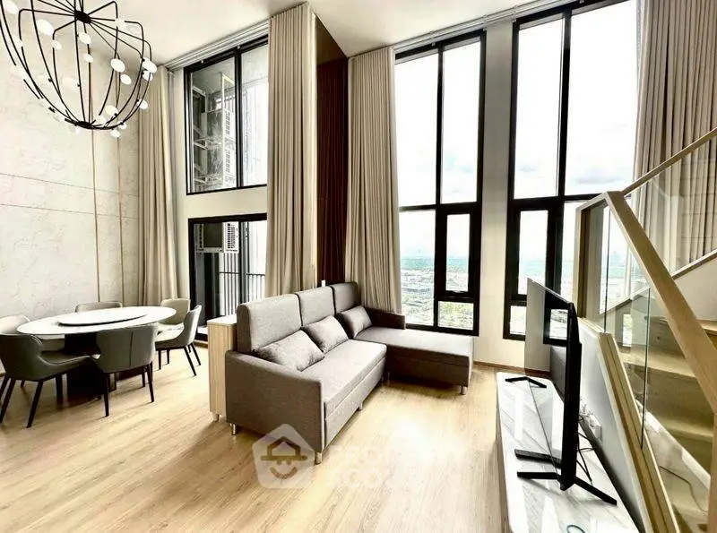 Luxurious modern living room with high ceilings and panoramic windows