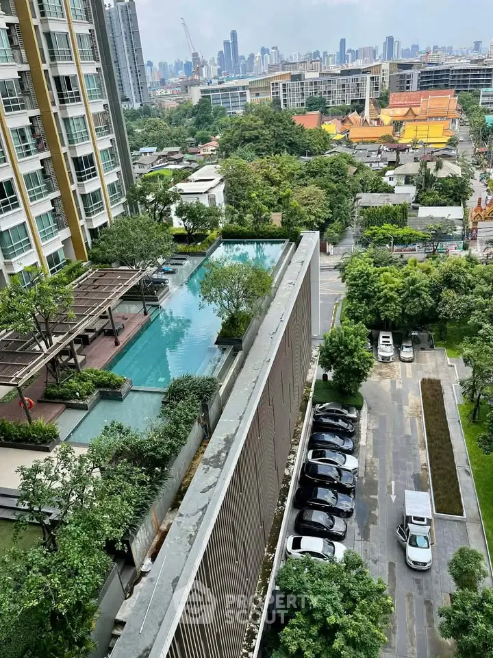 Stunning rooftop pool with cityscape view in modern urban residential complex.