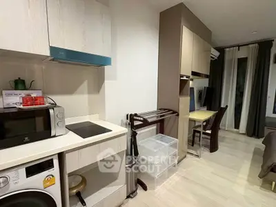 Modern apartment interior with kitchen and study area, featuring sleek appliances and contemporary design.