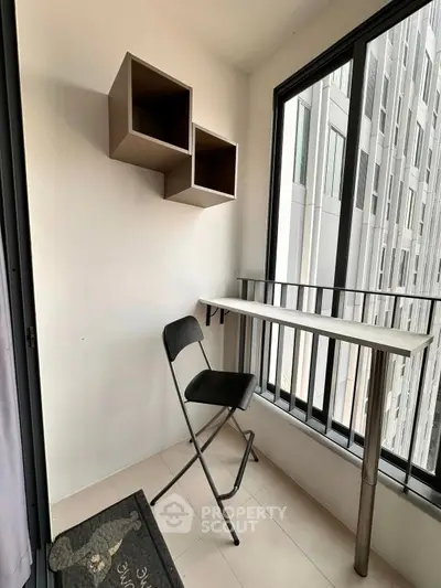 Cozy balcony with modern decor and city view, perfect for relaxation.