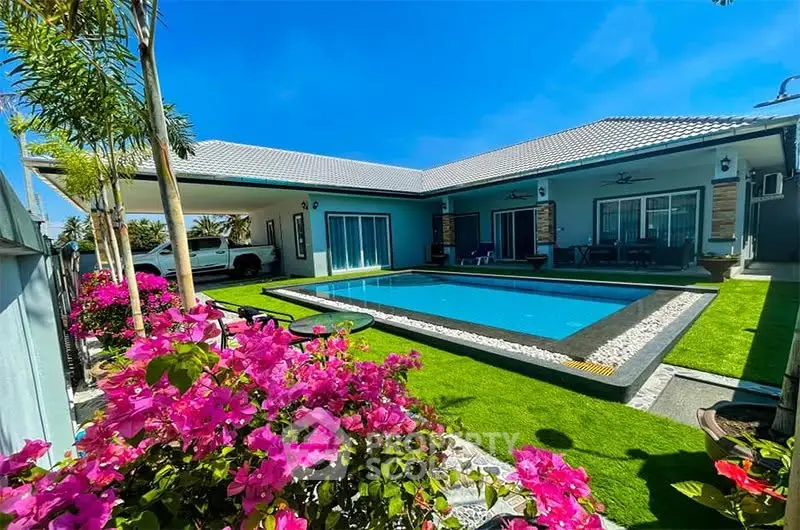 Luxurious villa with private pool and vibrant garden, perfect for tropical living.