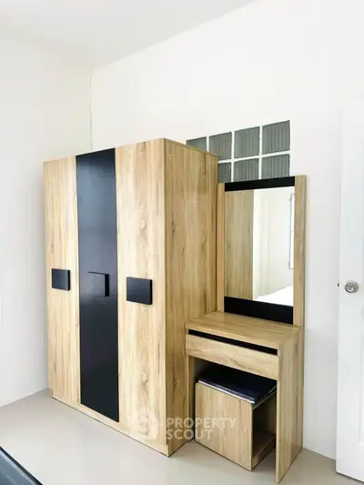 Modern bedroom with stylish wooden wardrobe and dressing table