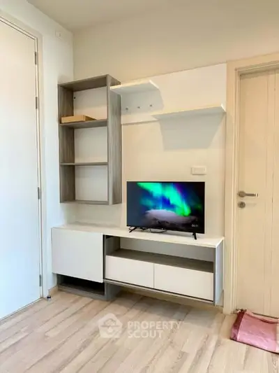Modern living room with sleek TV unit and stylish shelving, perfect for contemporary living.