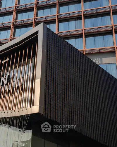 Modern building facade with sleek architectural design and large windows.