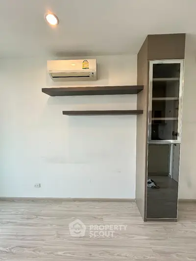 Modern minimalist interior with air conditioning and sleek shelving unit
