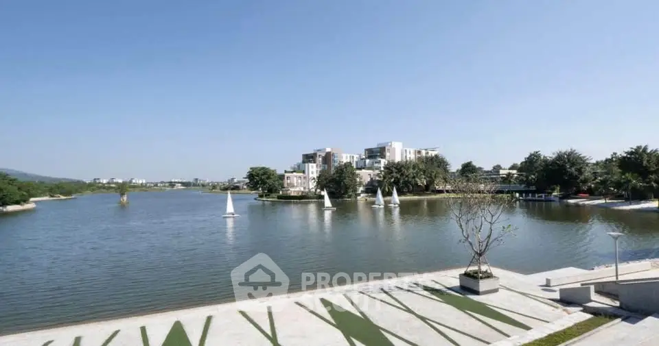 Stunning waterfront view with modern buildings and sailboats, perfect for luxury living.