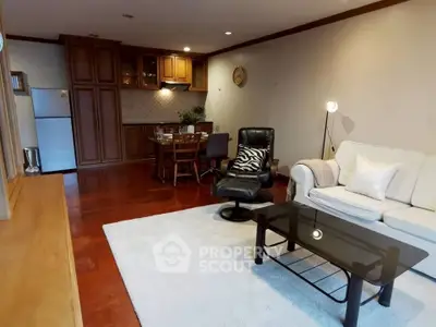 Spacious living room with elegant furniture and open kitchen layout, perfect for modern living.