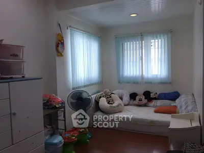 Cozy bedroom with playful decor and natural light