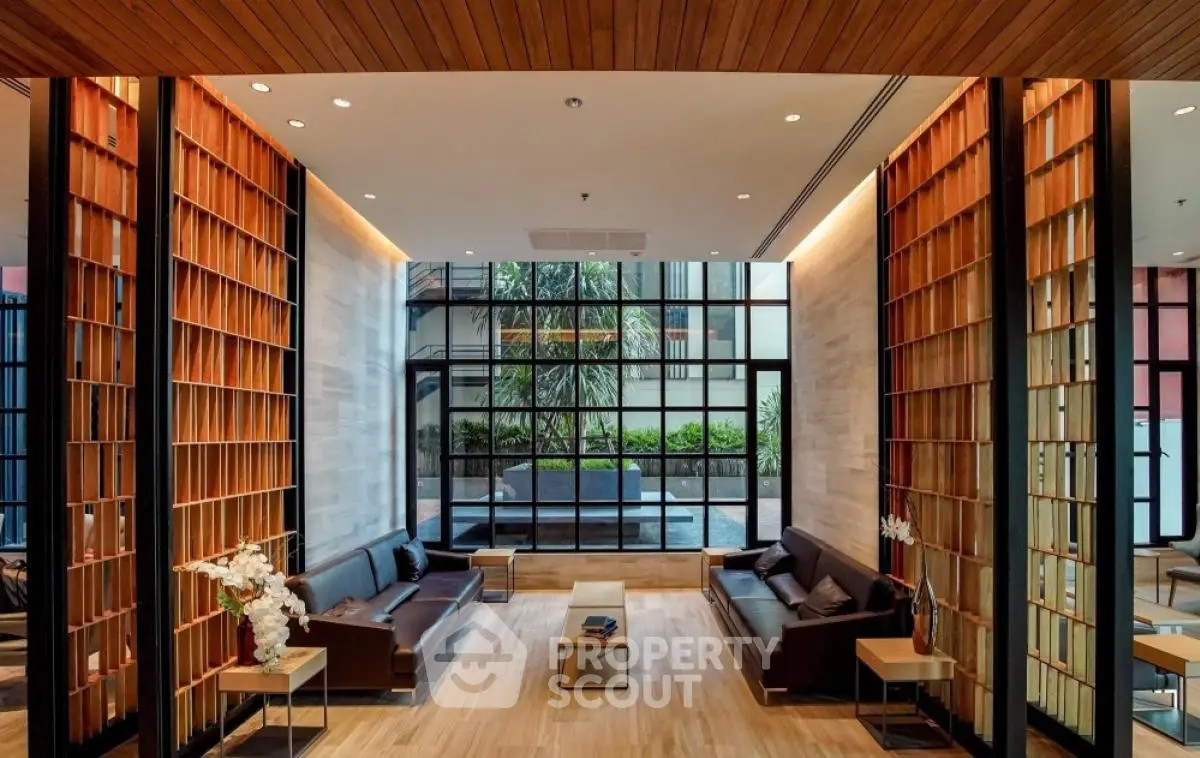 Luxurious modern living room with elegant wooden accents and large windows overlooking a garden.