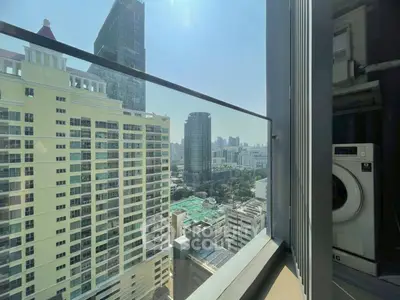 Stunning city view from high-rise balcony with washing machine setup