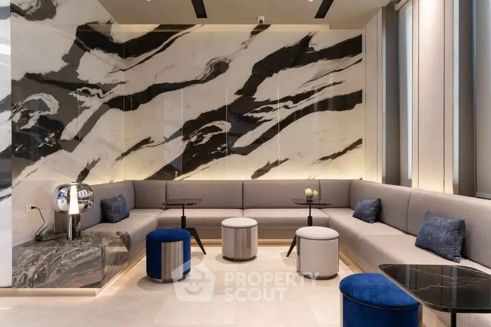 Luxurious modern living room with elegant marble wall and stylish seating area.