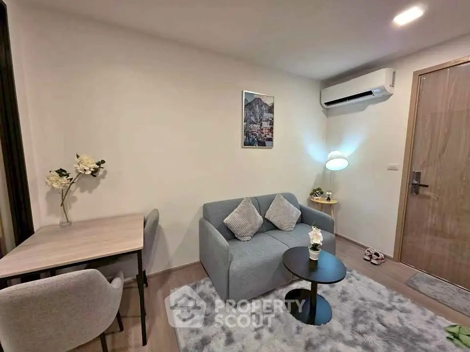 Cozy living room with modern decor and air conditioning in a stylish apartment.