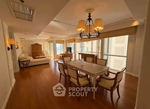 Spacious living room with elegant dining area and large windows in a luxury apartment.