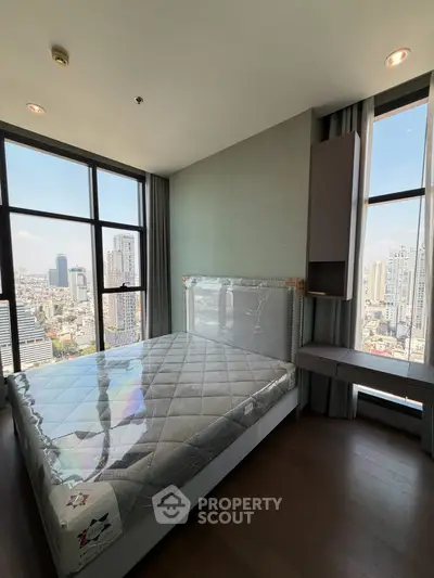 Luxurious bedroom with stunning city view in high-rise apartment