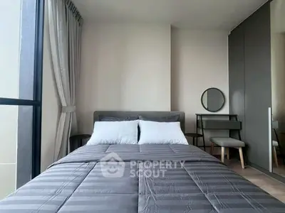 Modern bedroom with stylish decor and large window for natural light