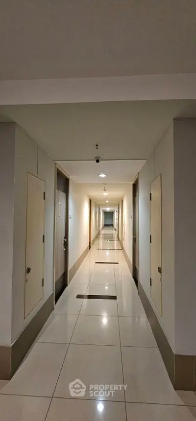 Modern apartment corridor with sleek design and polished tile flooring