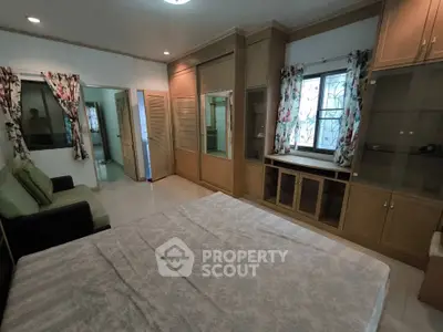 Spacious bedroom with built-in wardrobes and natural light