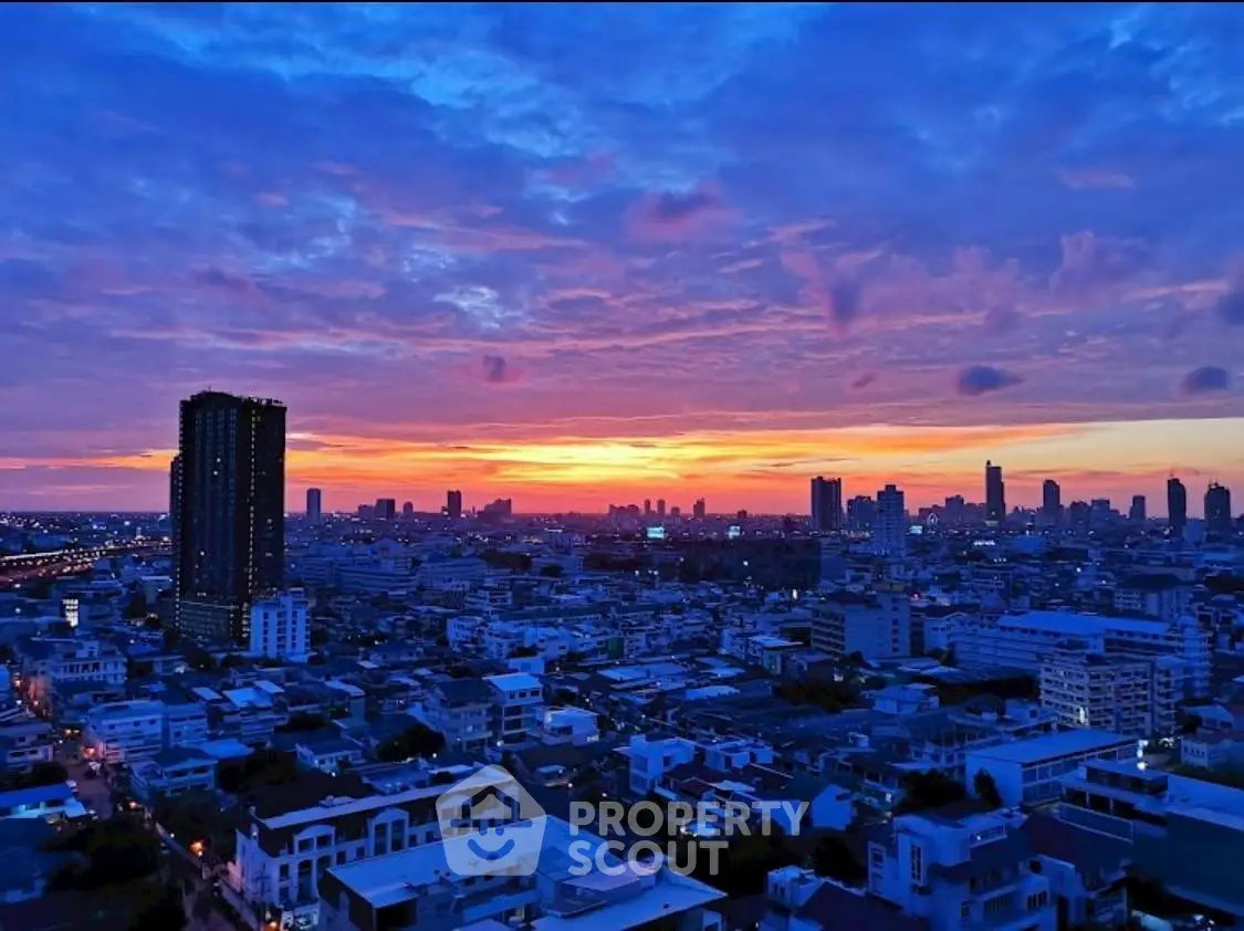 Stunning cityscape view at sunset with vibrant sky over urban skyline.