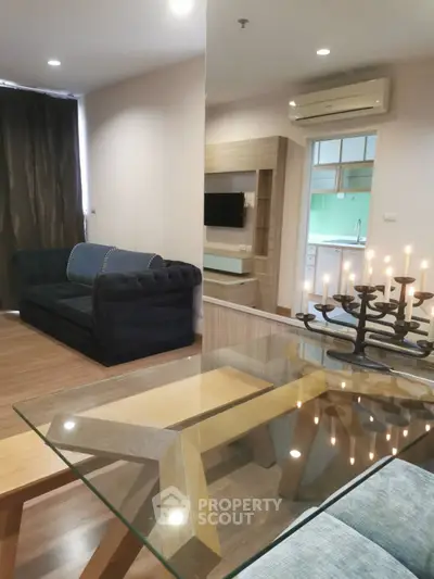 Modern living room with stylish furniture and open kitchen layout in a cozy apartment.