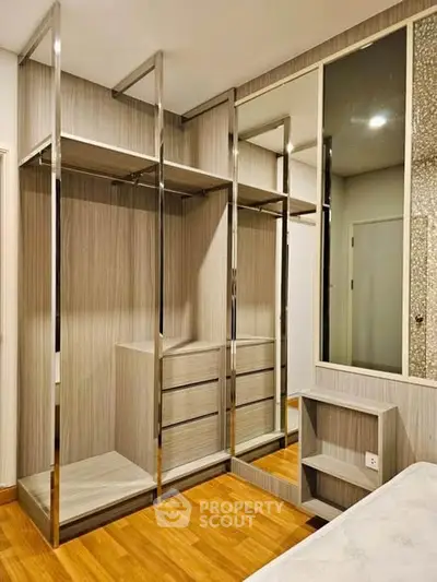 Modern bedroom with sleek built-in wardrobe and wooden flooring