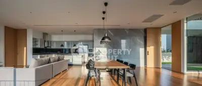 Spacious modern living and dining area with open kitchen and elegant design.