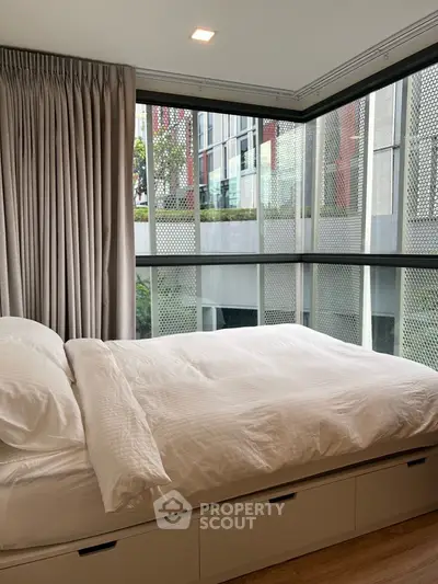 Modern bedroom with large windows and stylish decor in urban apartment