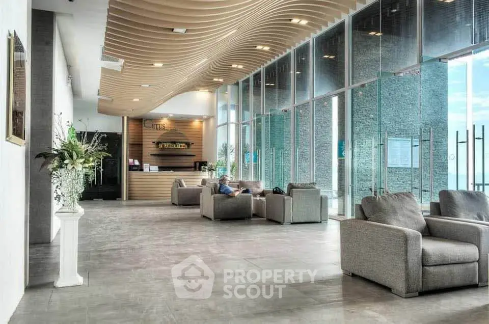 Luxurious modern lobby with elegant seating and stunning architectural ceiling design.