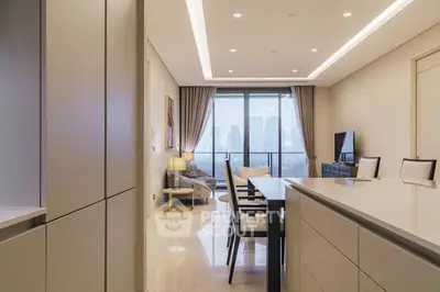 Luxurious modern living room with city view, elegant furniture, and ample natural light.