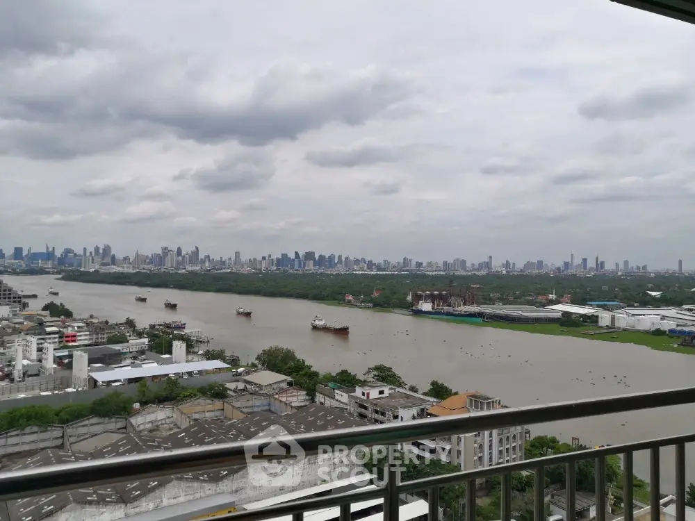 Stunning river view from high-rise balcony overlooking city skyline.