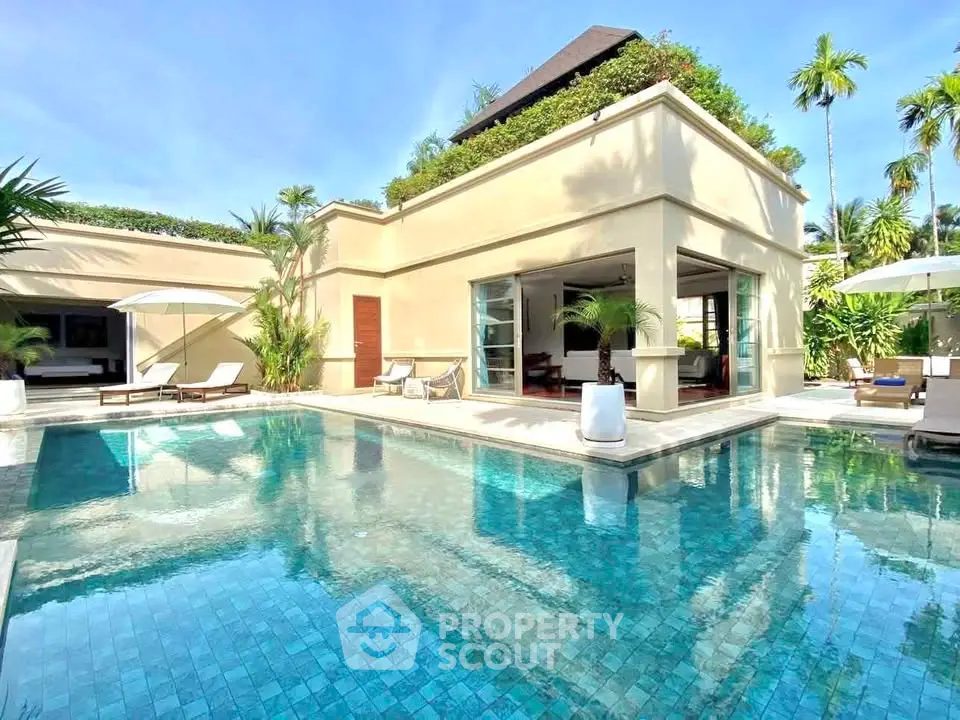Luxurious villa with private pool and lush greenery, perfect for tropical living.
