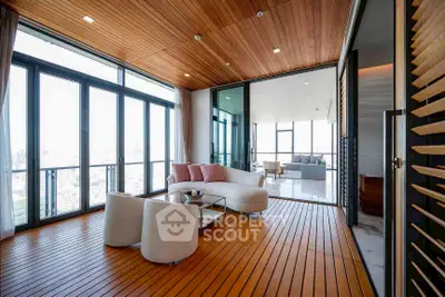 Luxurious modern living room with floor-to-ceiling windows and stunning city view.